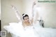 A woman in a bathtub with foam on her body.