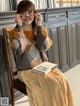 a woman sitting on a chair holding a book