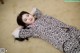 A woman laying on the floor with her head on her hands.