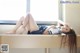 A woman laying on top of a wooden table.
